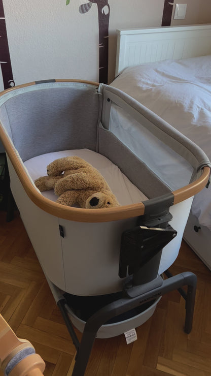 Video showing how to attach Maxi-cosi_Iora black CribClamp to the bedside crib with a little dutch musical mobile. View of the Maxi-cosi co-sleeper and baby mobile attachment adapter bracket